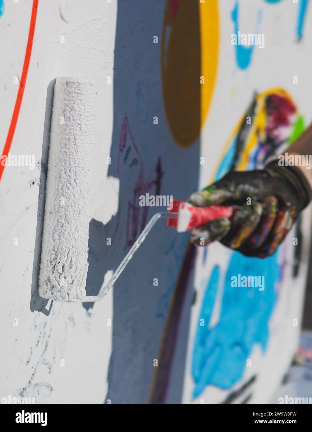 Process of creating graffiti, street artist with aerosol spray paint ...