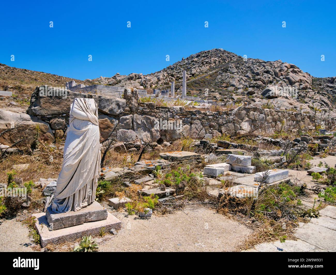 Headless Statue and Mount Kynthos, Delos Archaeological Site, Delos Island, Cyclades, Greece Stock Photo