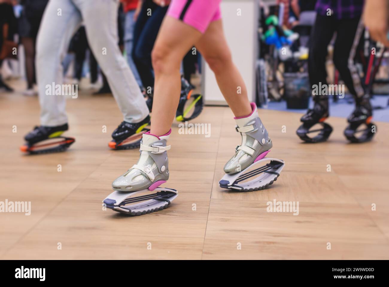 Female Trainer Doing Exercises Jumping In The Kangoo Jumps Boots