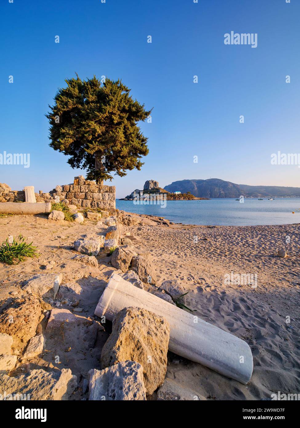 St. Stefanos Basilica Ruins and Kastri Island at sunset, Agios Stefanos Beach, Kos Island, Dodecanese, Greece Stock Photo