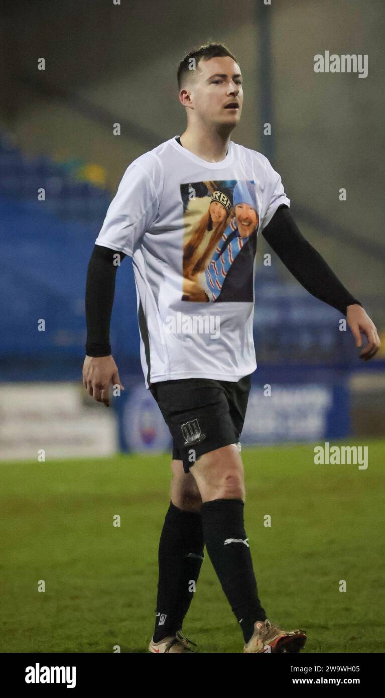 Mourneview Park, Lurgan, County Armagh, Northern Ireland, UK. 30th Dec 2023. Sports Direct Premiership – Glenavon v Ballymena United Action from today's game at Mourneview Park (Glenavon in blue). Ballymena United player Andy McGrory wearing a t-shirt with a picture of Lydia Ross and her father on it. The 21 year-old Ballymena fan died following a road traffic accident on Thirsday. A minutes applause in her memory was held 21 minutes into the game.  Credit: CAZIMB/Alamy Live News. Stock Photo