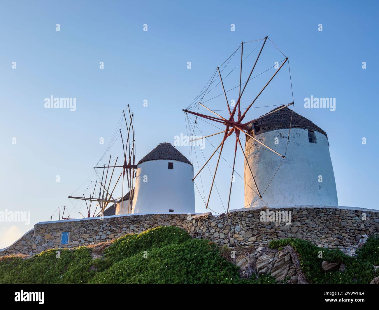 Chora Windmills at sunrise, Mykonos Town, Mykonos Island, Cyclades, Greece Stock Photo