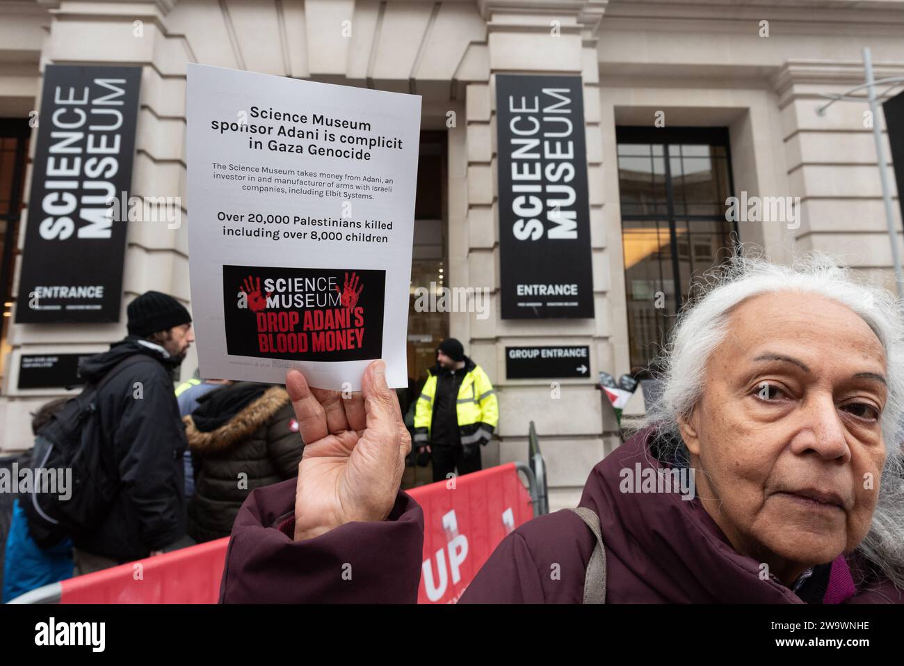 London, UK. 30 December, 2023. Palestine supporters protest sponsorship of the Science Museum's forthcoming 'Energy Revolution' gallery by Indian conglomerate Adani, which manufactures weapons with and supplies arms to Israel. Activists laid symbolic baby coffins to highlight the huge death toll and destruction in Gaza, for which Israel has been accused of genocide, and raised concerns of the ethics of the museum associating with a company with close ties to the conflict. Credit: Ron Fassbender/Alamy Live News Stock Photo