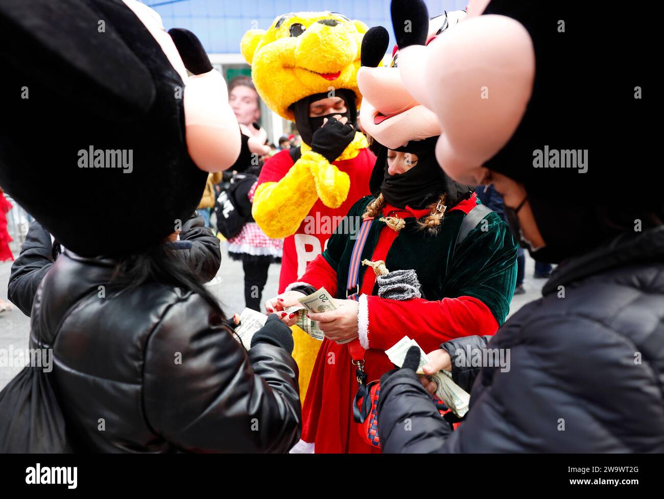 New York, United States. 30th Dec, 2023. People dressed in Minnie and Mickey Mouse costumes count their tips while working in Times Square on the eve of New Year's Eve celebrations in New York City on Saturday December 30, 2023. Photo by John Angelillo/UPI Credit: UPI/Alamy Live News Stock Photo