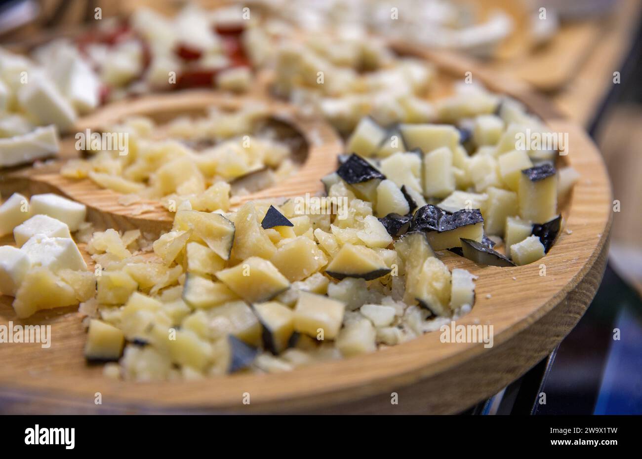 various cheeses for tasting on a wooden plate closeup Stock Photo