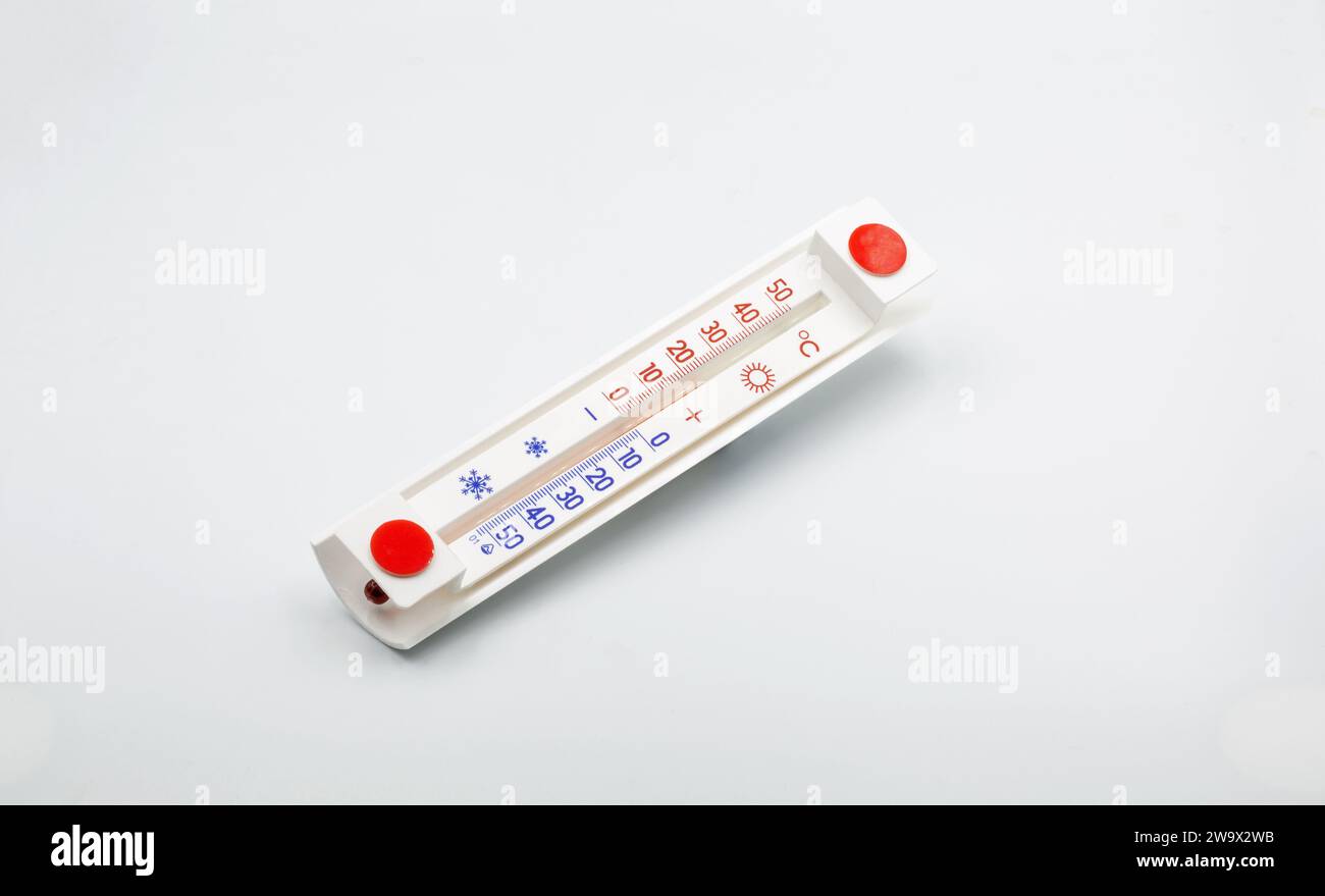 simple household thermometer for measuring outside air temperature closeup on white Stock Photo