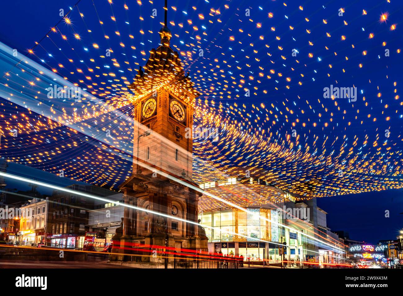 Brighton, East Sussex, UK  30 December 2023. The Jubilee Clock tower is shrowded in Christmas lights that are flickering and blowing around in the stormy weather as the traffic surrounds the area and shoppers are looking for sale bargains in this busy town on the south coast.©Sarah Mott / Alamy Live News. Stock Photo