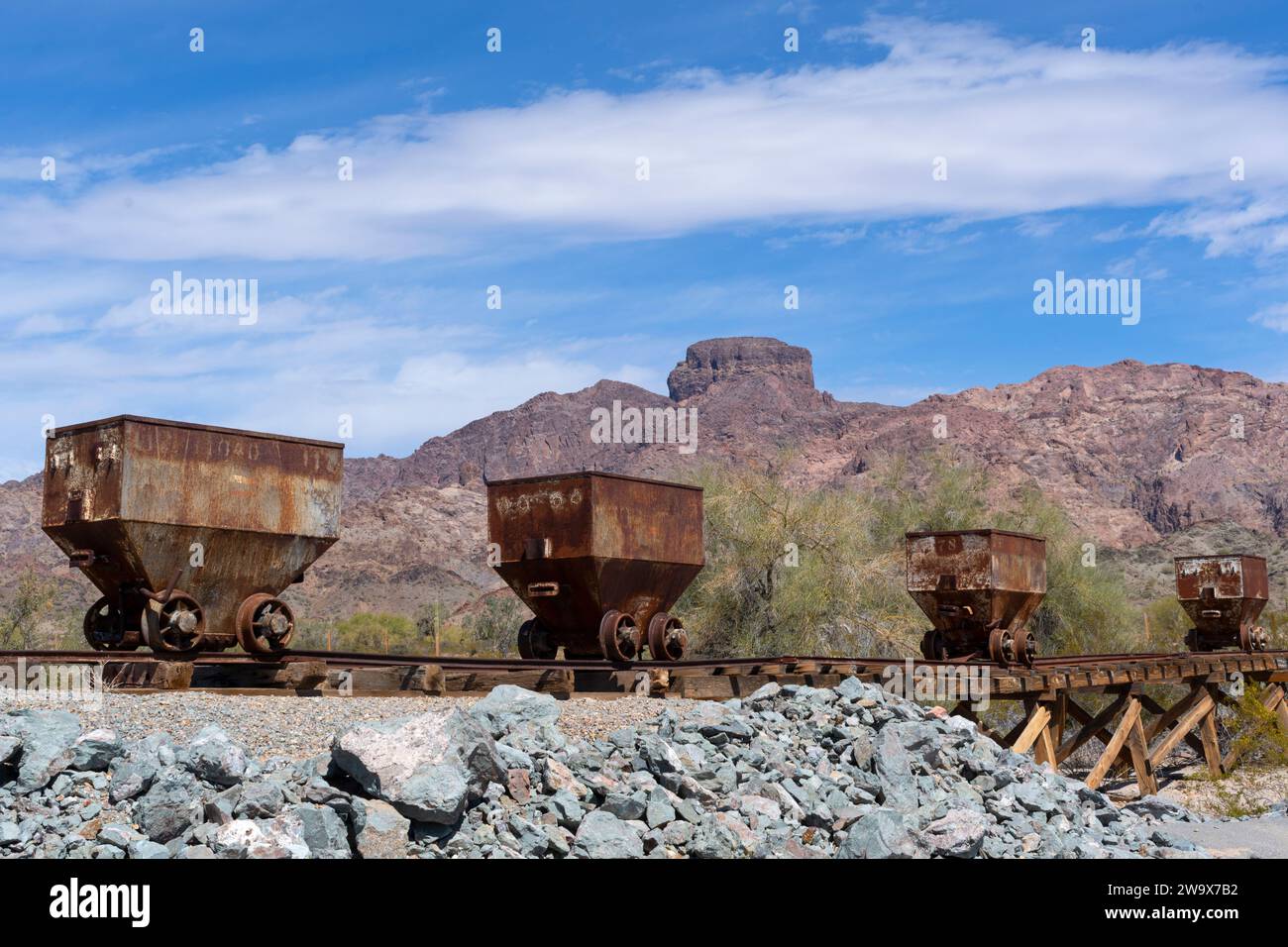 Ore cars at the Hull Mine, Castle Dome on horizon, Arizona Stock Photo
