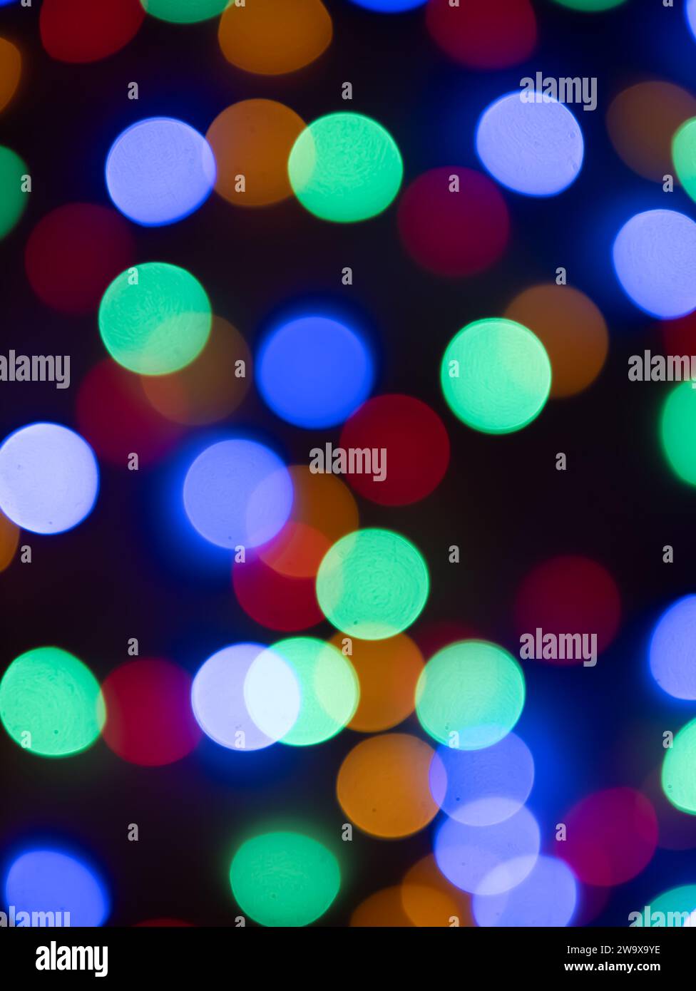 abstract background with blured colored light circles on dark background Stock Photo