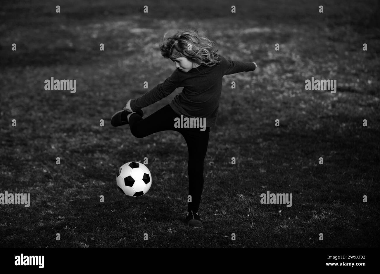 Soccer kid. Kids play football on summer stadium field. Little child