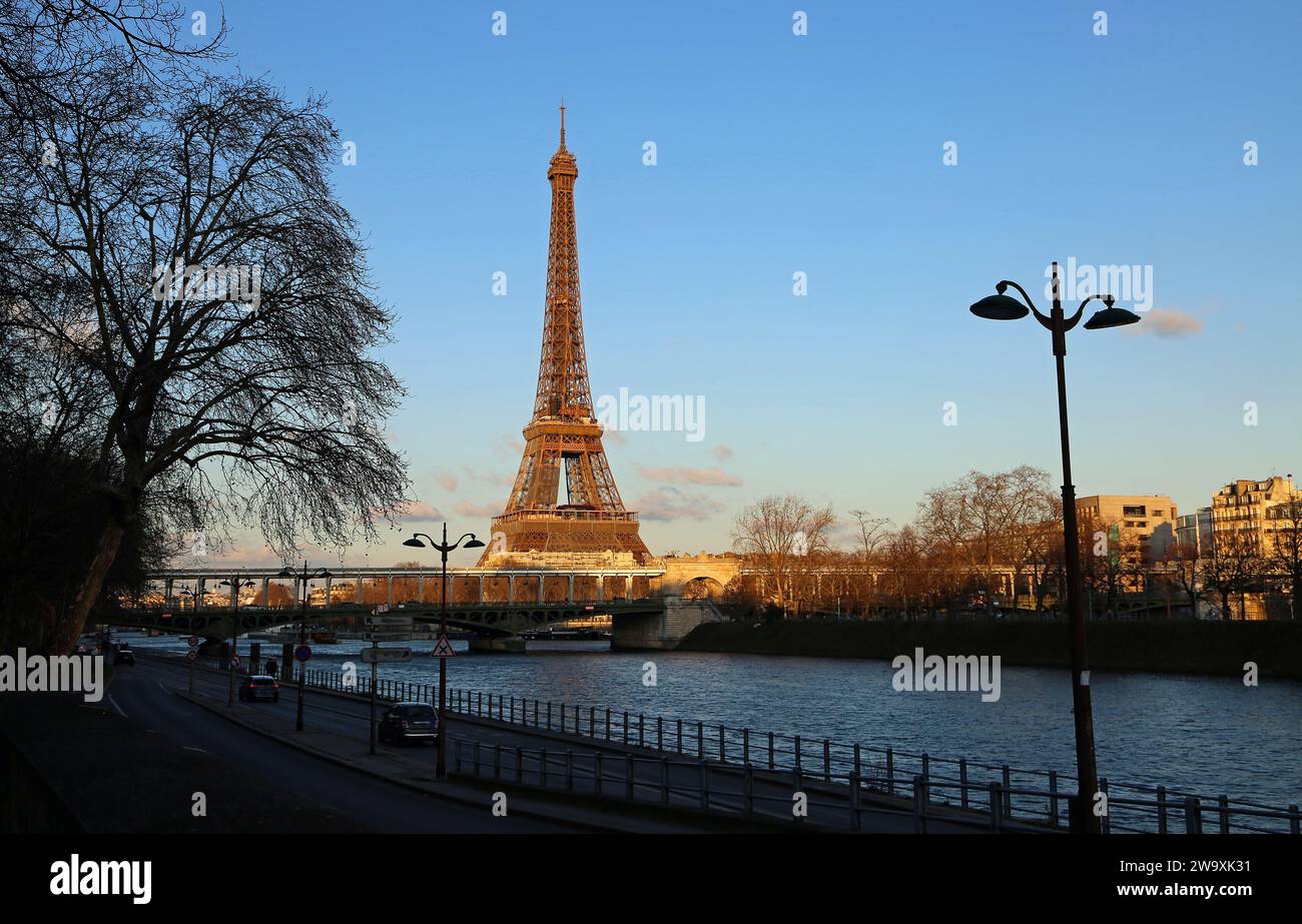 Eiffel tower on Seine River at sunset - Paris Stock Photo