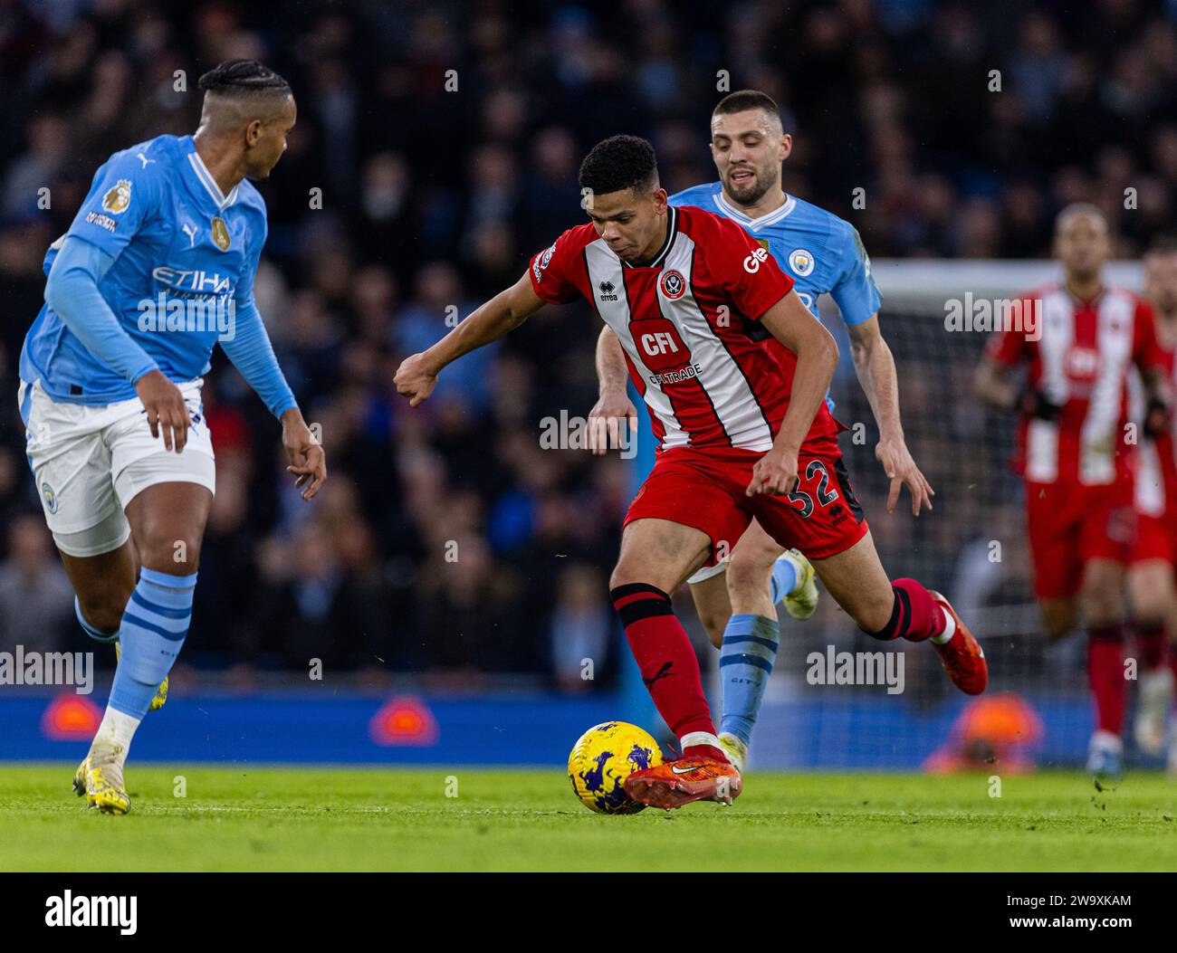 (231231) -- MANCHESTER, Dec. 31, 2023 (Xinhua) -- Sheffield United's William Osula (front) competes during the English Premier League match between Manchester City and Sheffield United in Manchester, Britain, on Dec. 30, 2023. (Xinhua) FOR EDITORIAL USE ONLY. NOT FOR SALE FOR MARKETING OR ADVERTISING CAMPAIGNS. NO USE WITH UNAUTHORIZED AUDIO, VIDEO, DATA, FIXTURE LISTS, CLUB/LEAGUE LOGOS OR 'LIVE' SERVICES. ONLINE IN-MATCH USE LIMITED TO 45 IMAGES, NO VIDEO EMULATION. NO USE IN BETTING, GAMES OR SINGLE CLUB/LEAGUE/PLAYER PUBLICATIONS. Stock Photo