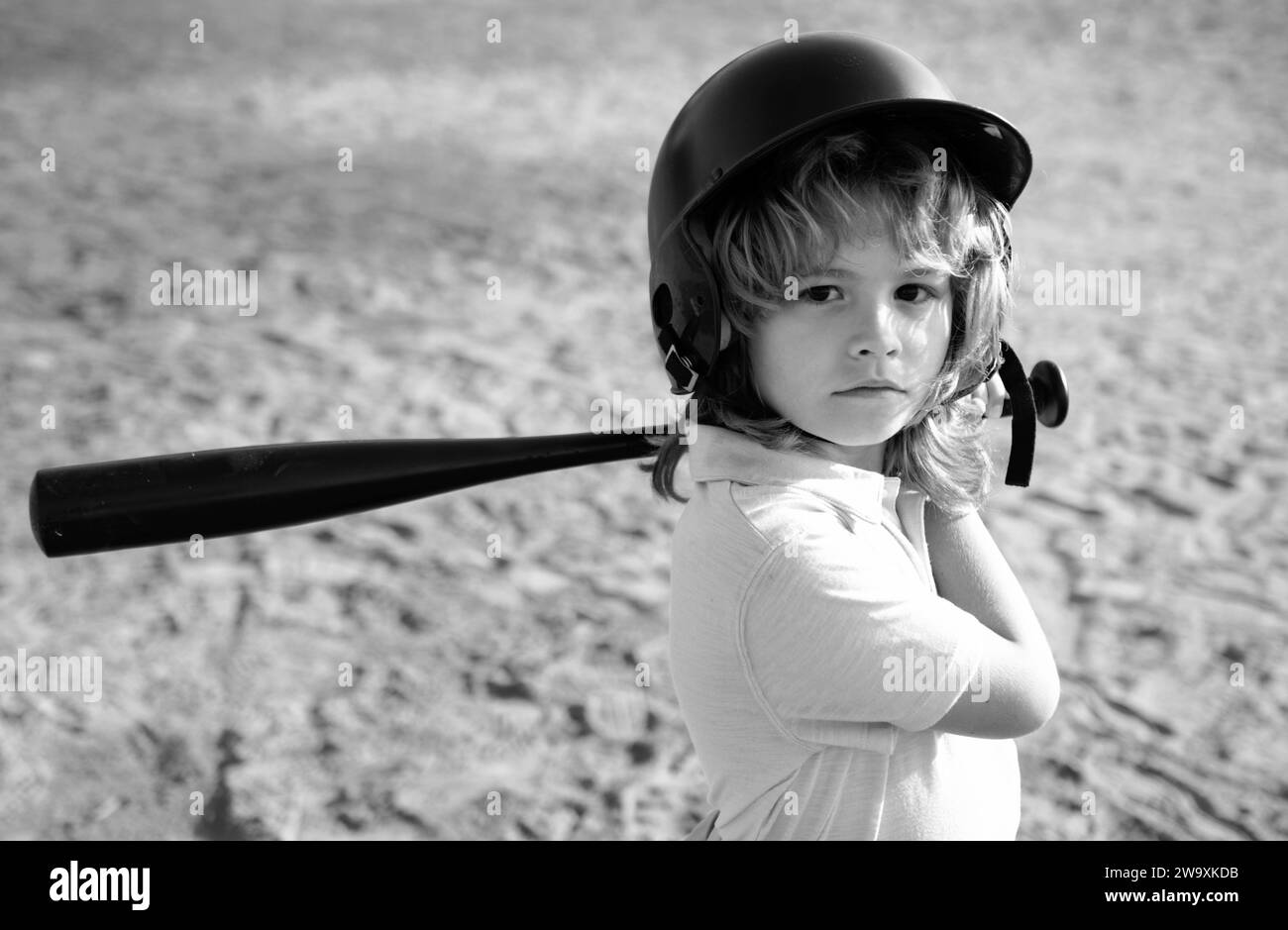 Child batter about to hit a pitch during a baseball game. Kid baseball