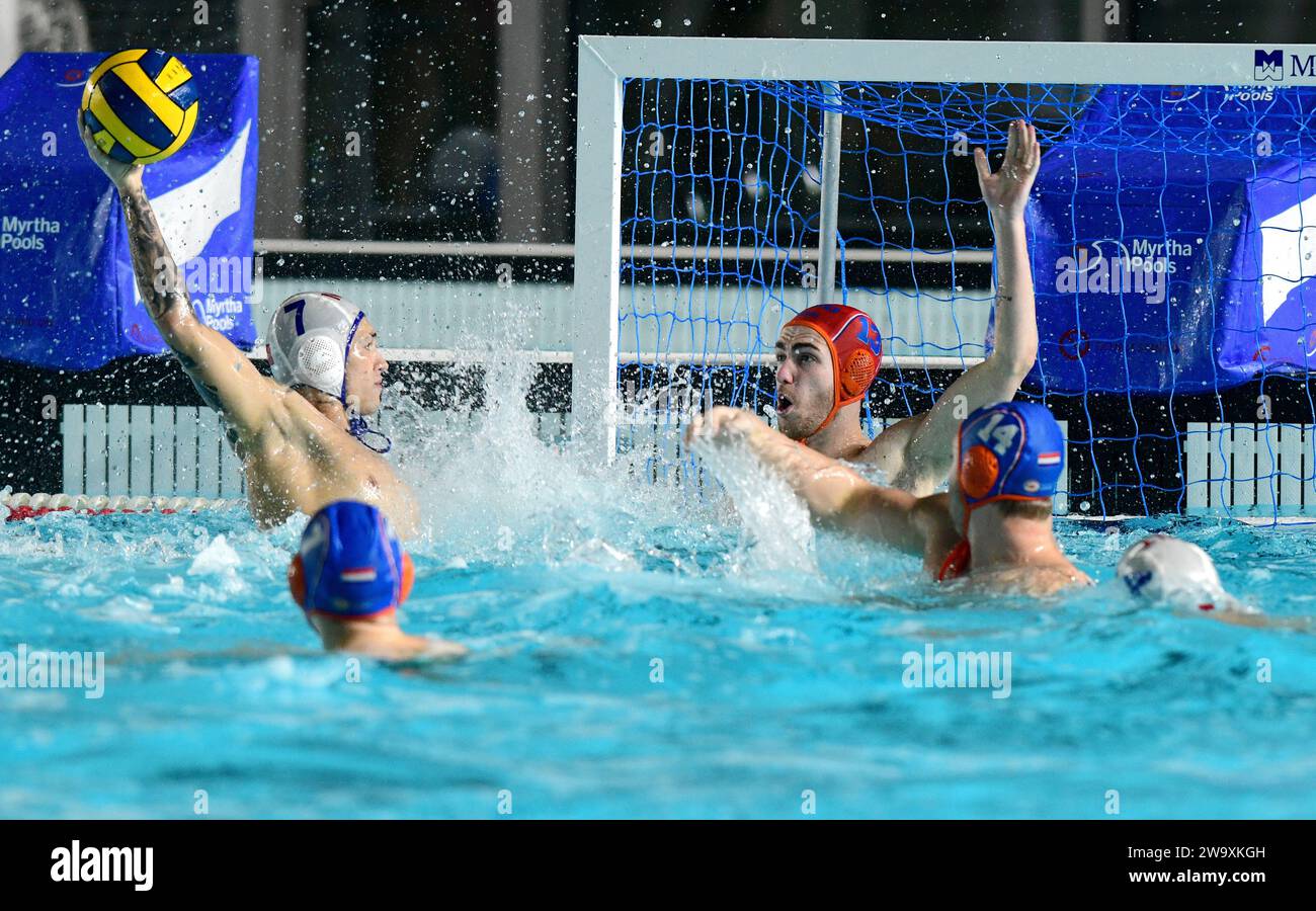 Cospicua, Malta. 30th Dec, 2023. Malta's Jake Muscat Melito (1st L) takes a shot at goal during a Christmas International Waterpolo match between Malta and the Netherlands in Cospicua, Malta, on Dec. 30, 2023. Credit: Jonathan Borg/Xinhua/Alamy Live News Stock Photo