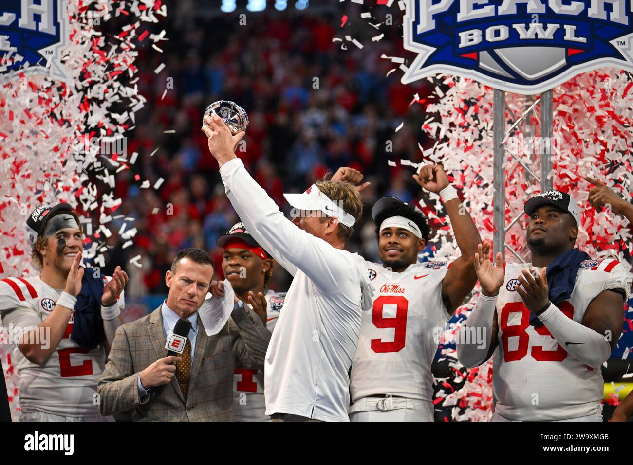 Atlanta, United States. 30th Dec, 2023. Mississippi head coach Lane Kiffin holds aloft the Chick-fil-A Peach Bowl trophy as he celebrates with quarterback Jaxson Dart (2) and wide receiver Tre Harris (9) after the Peach Bowl NCAA college football game Saturday, Dec. 30, 2023, in Atlanta, Ga. Mississippi won 38-25. Photo by David Tulis/UPI Credit: UPI/Alamy Live News Stock Photo