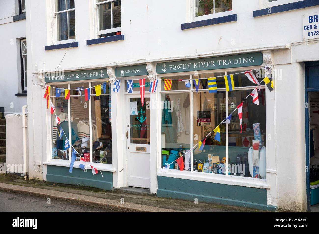 Fowey in Cornwall, a port fishing town on the south coast of England, chandlery and coffee shop with bunting outside,UK,2023 Stock Photo