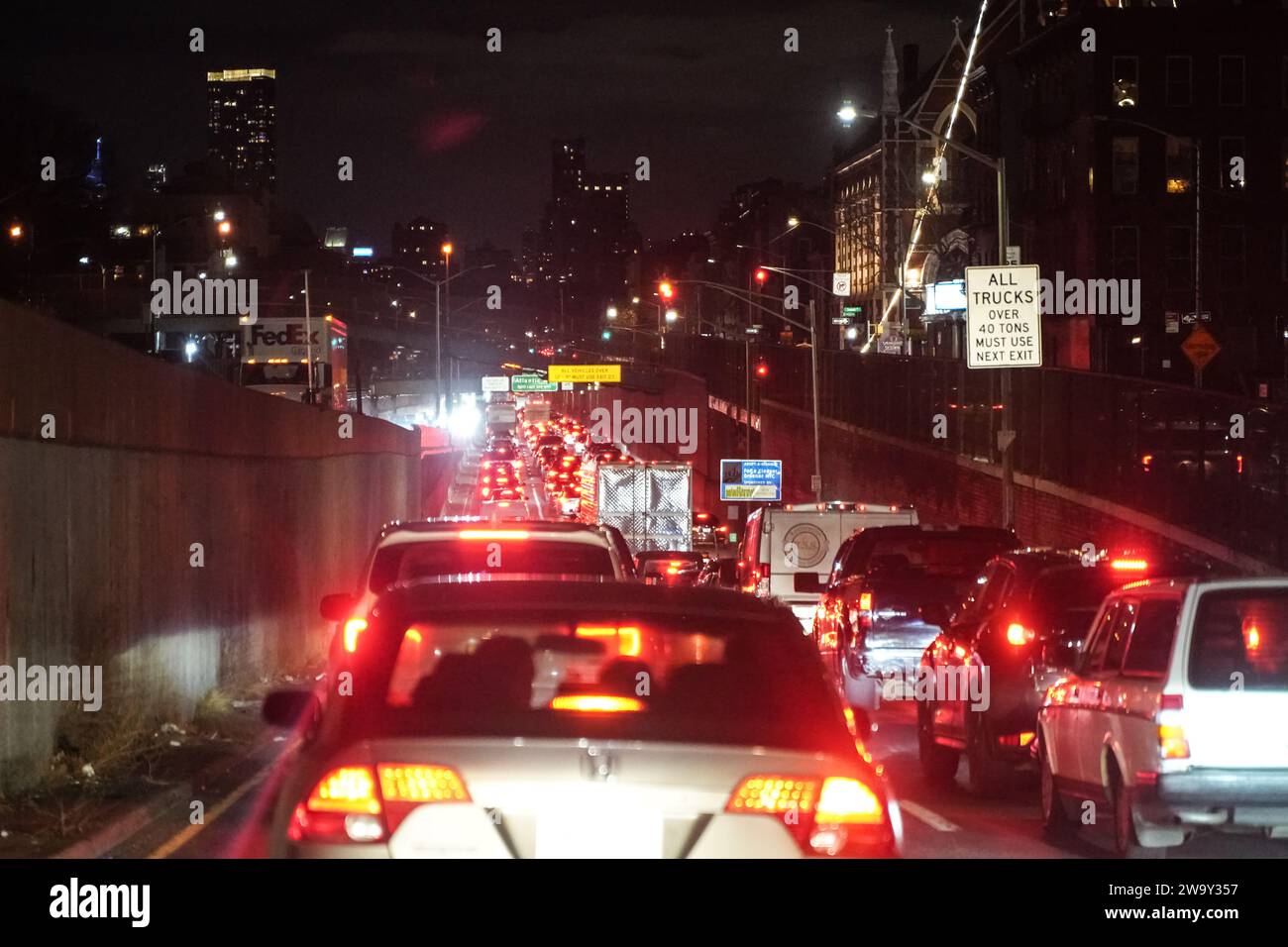 A heavy traffic is seen on the highway of New York City at night. Road