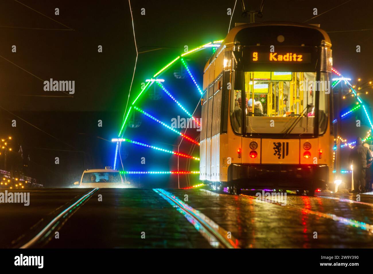 Dresden illuminated ferris wheel, bridge Augustusbrücke, streetcar