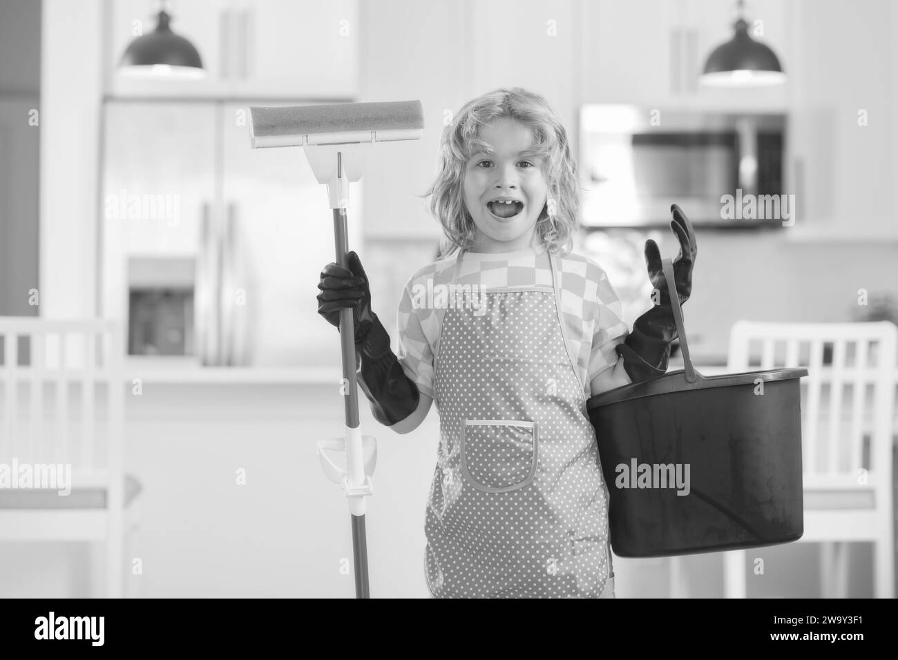 Portrait of child helping with housework, cleaning the house. Housekeeping, home chores. Stock Photo