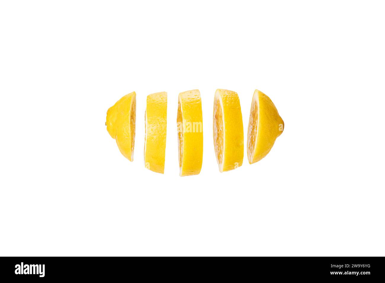 Zitrone in Scheiben geschnitten und frei schwebend vor weißem Hintergrund. A lemon cut in slices before a white backdrop Stock Photo
