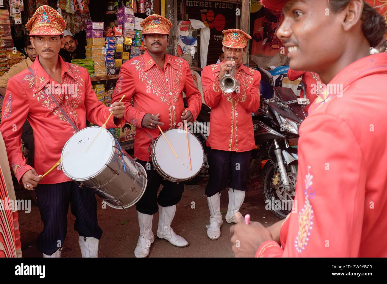 A Indian wedding and festival band, with red uniformed drummers and a