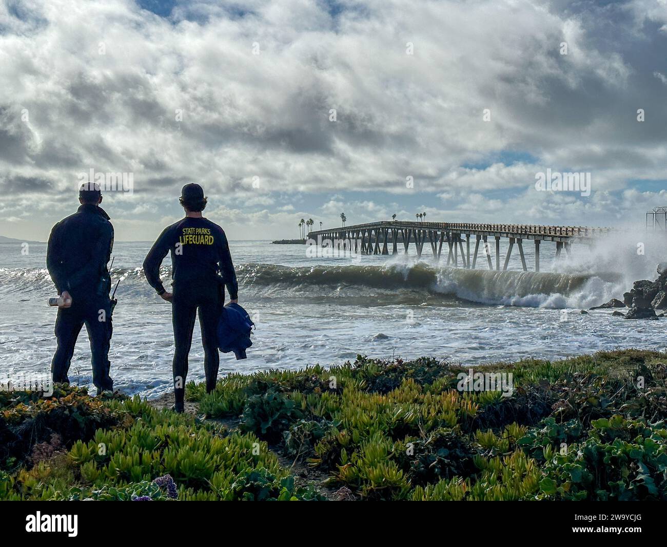 December 30, 2023, Santa Barbara/Ventura, California, U.S.A: Two experienced State Park Life Guards keep an eye on dare-devil surfers and onlookers as Monster, King Tides bring dramatic waves after the storm to beautiful Rincon Point, south of Carpinteria in Santa Barbara County and just North of Ventura, on December 30, 2023 (Credit Image: © Amy Katz/ZUMA Press Wire) EDITORIAL USAGE ONLY! Not for Commercial USAGE! Stock Photo