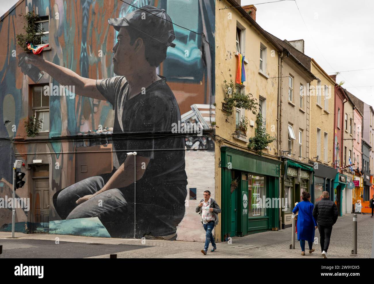 Ireland, Munster, Waterford, Apple Market, Michael Street gable end mural painting of boy spray painting graffiti Stock Photo