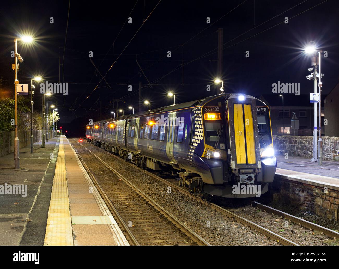 Scotrail Siemens class 380 electric train 380108 calling at Stevenston (Ayrshire) railway station, Scotland, UK at night. Stock Photo