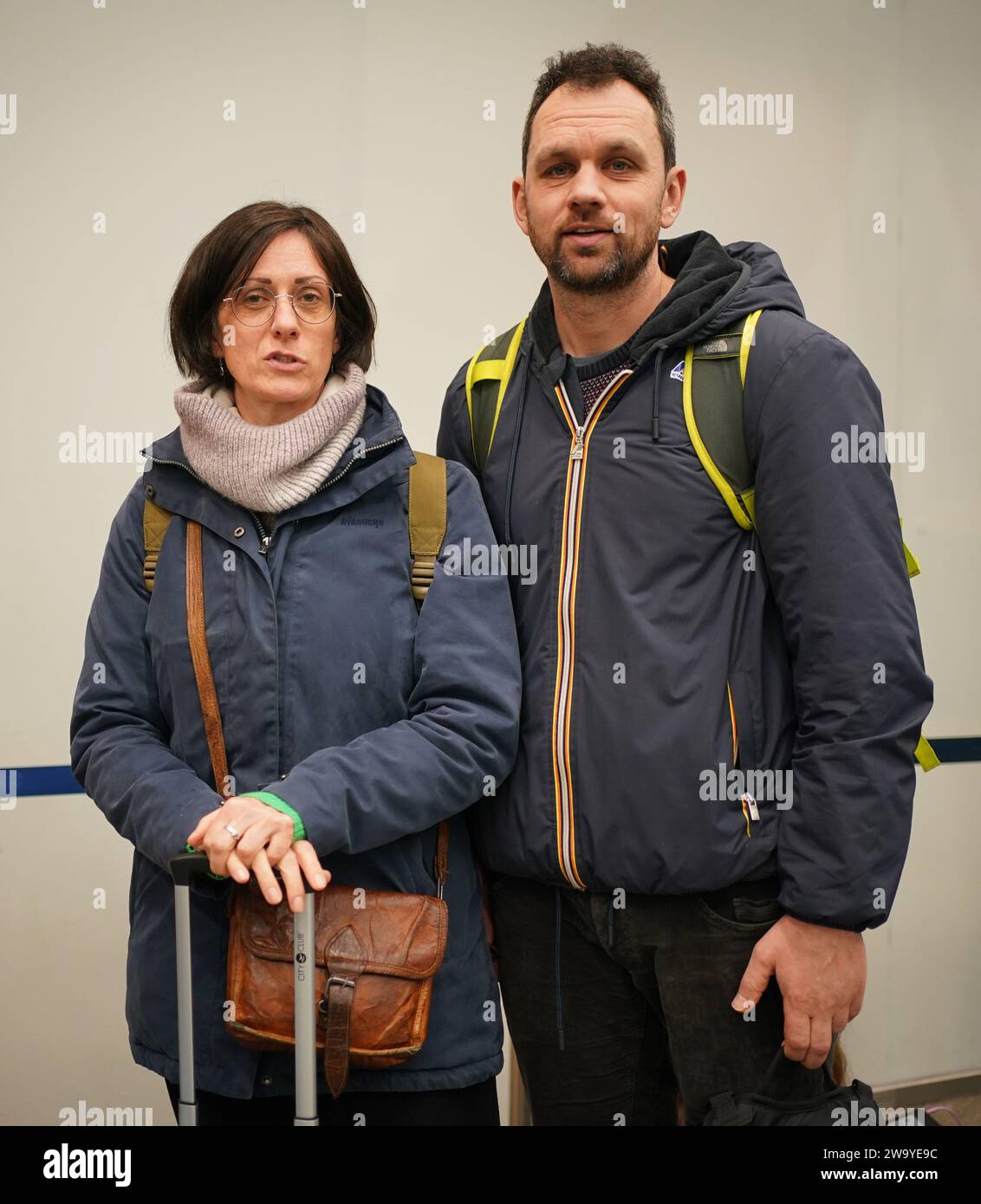 Maes Bert, 45 and her partner Lievens Nele, 45, from Brussels, who are hoping to get home to their daughter in time for New Year celebrations, waiting in line at Eurostar in St Pancras International station, central London. Eurostar have announced all of its services will resume on Sunday after flooding in tunnels under the River Thames was brought under control, although speed restrictions may lead to delays. Picture date: Sunday December 31, 2023. Stock Photo