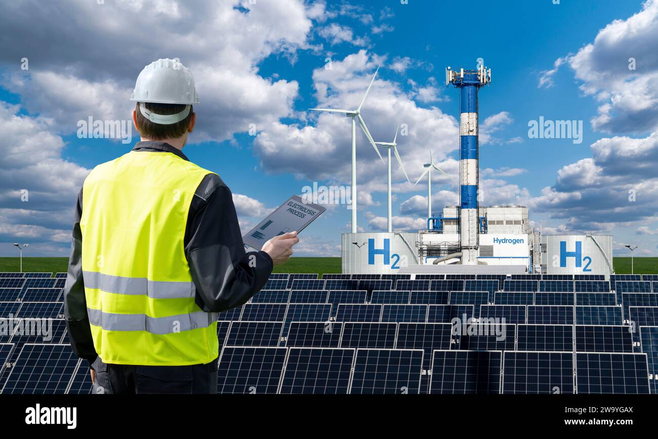 Engineer with tablet computer on a background of Hydrogen factory... Stock Photo