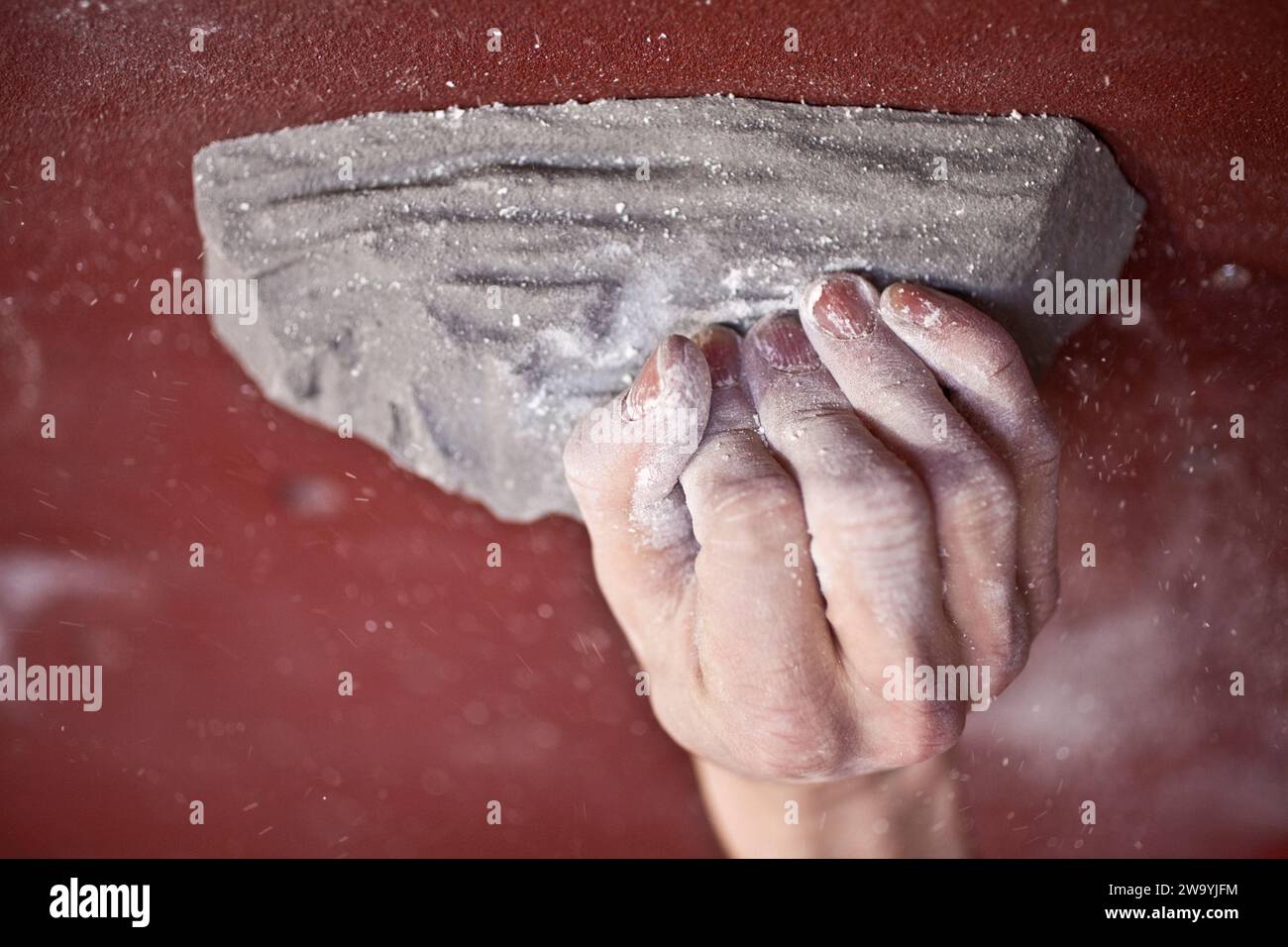 the hand of a climber on a hold in a climbing hall Stock Photo