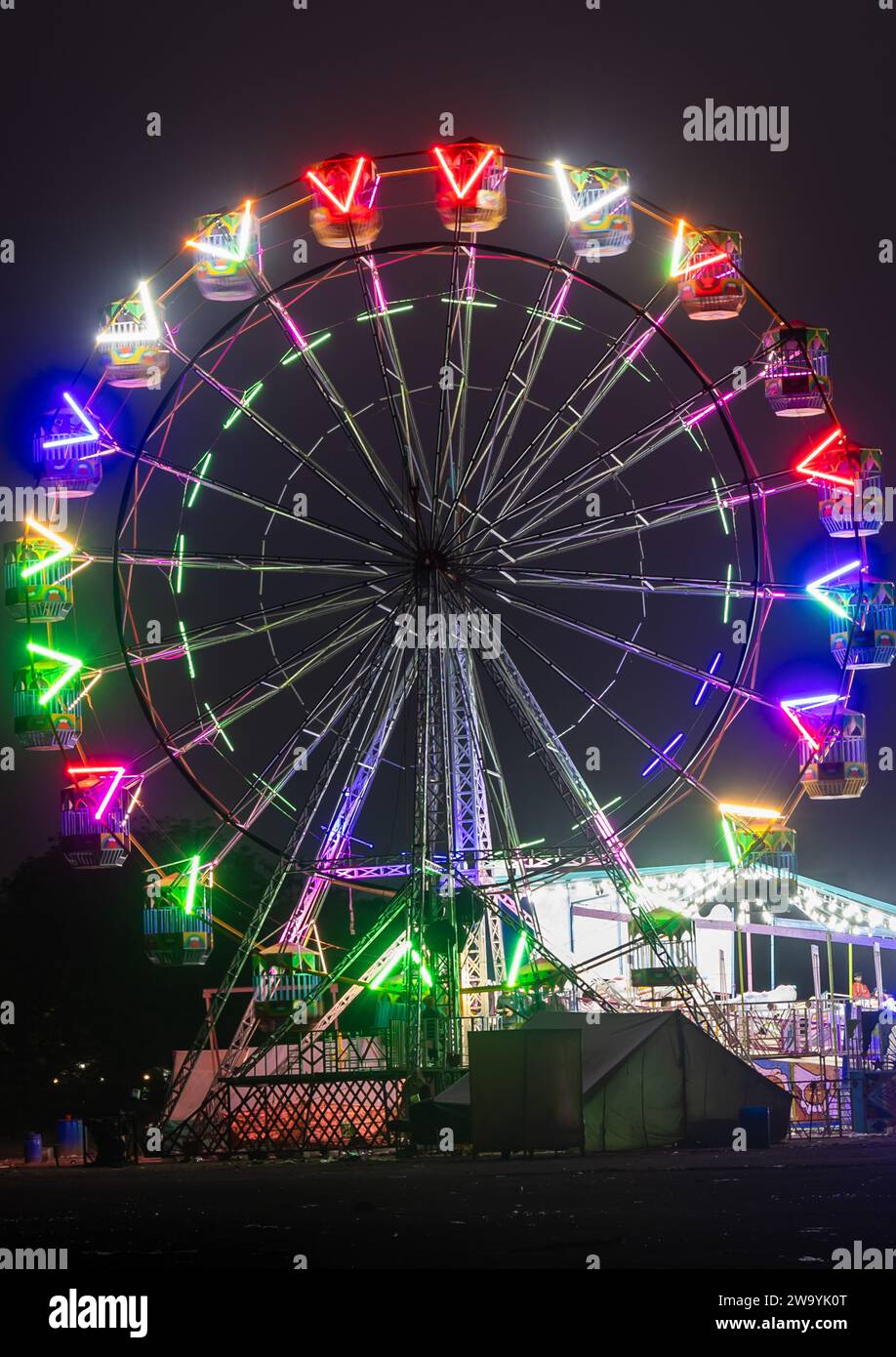 merry go round swing at night with colorful light at city fair ground