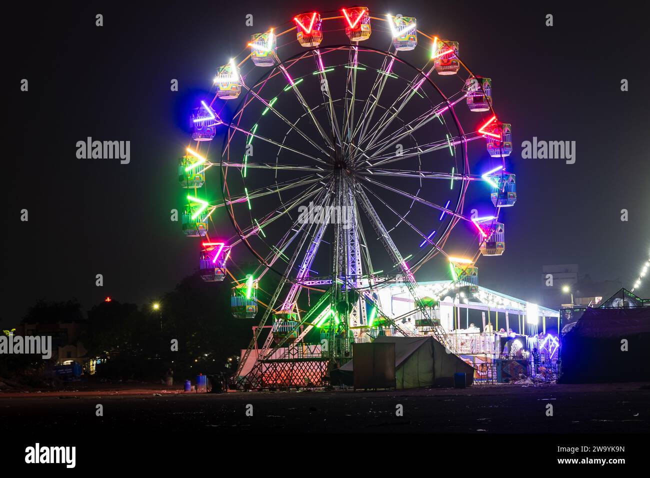 merry go round swing at night with colorful light at city fair ground from different angle Stock Photo