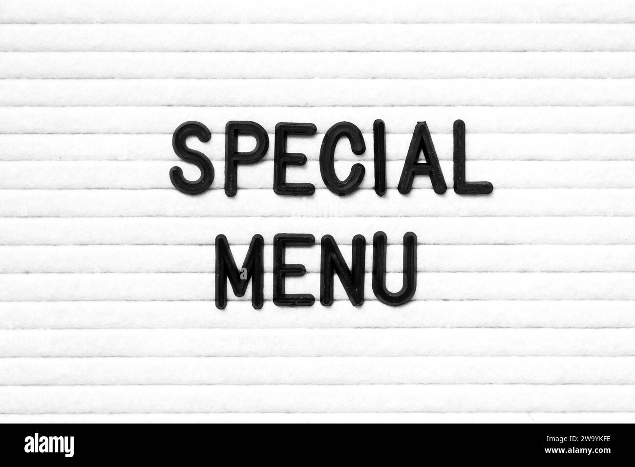 Black color letter in word special menu on white felt board background ...