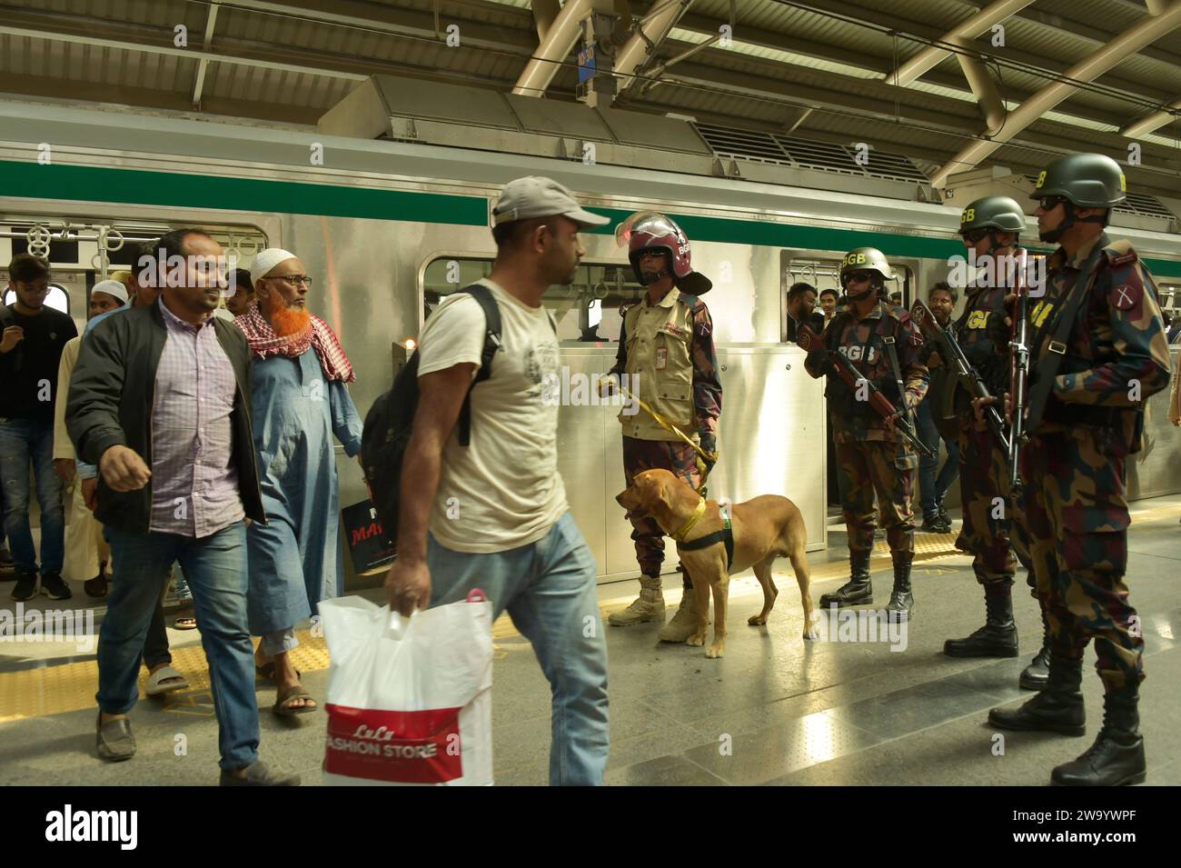 Dhaka. 31st Dec, 2023. Members of the Border Guard Bangladesh (BGB) dog squad unit work at a metro rail station in Dhaka, Bangladesh on Dec. 31, 2023. Authorities in Bangladesh have tightened security in capital Dhaka for New Year's Eve a week ahead of general elections to be held in the South Asian country. Law enforcers came out in full force in parts of the capital on Sunday to ensure security on the last night of 2023. Credit: Xinhua/Alamy Live News Stock Photo