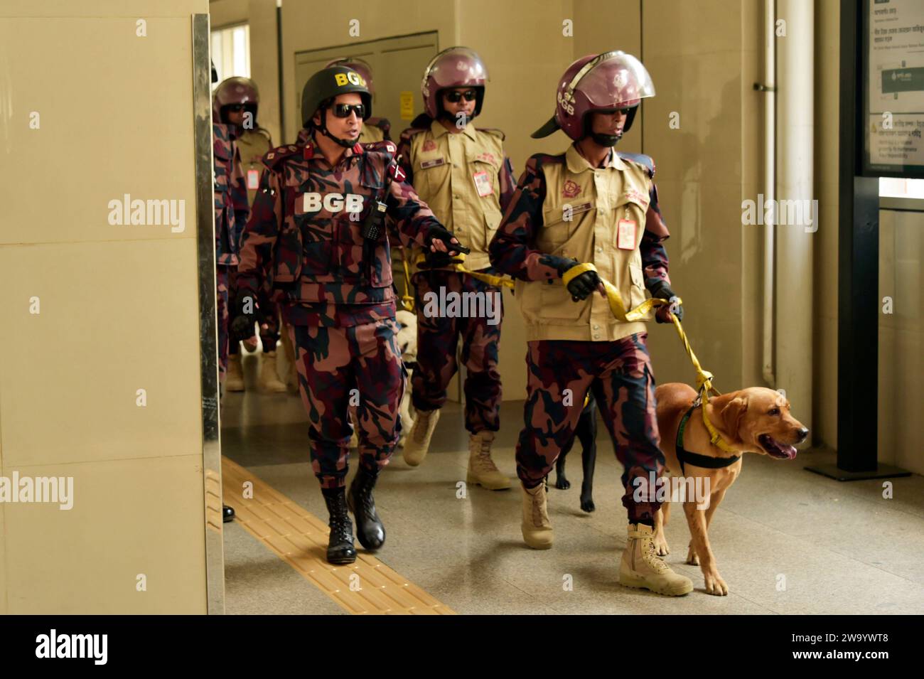 Dhaka. 31st Dec, 2023. Members of the Border Guard Bangladesh (BGB) dog squad unit work at a metro rail station in Dhaka, Bangladesh on Dec. 31, 2023. Authorities in Bangladesh have tightened security in capital Dhaka for New Year's Eve a week ahead of general elections to be held in the South Asian country. Law enforcers came out in full force in parts of the capital on Sunday to ensure security on the last night of 2023. Credit: Xinhua/Alamy Live News Stock Photo