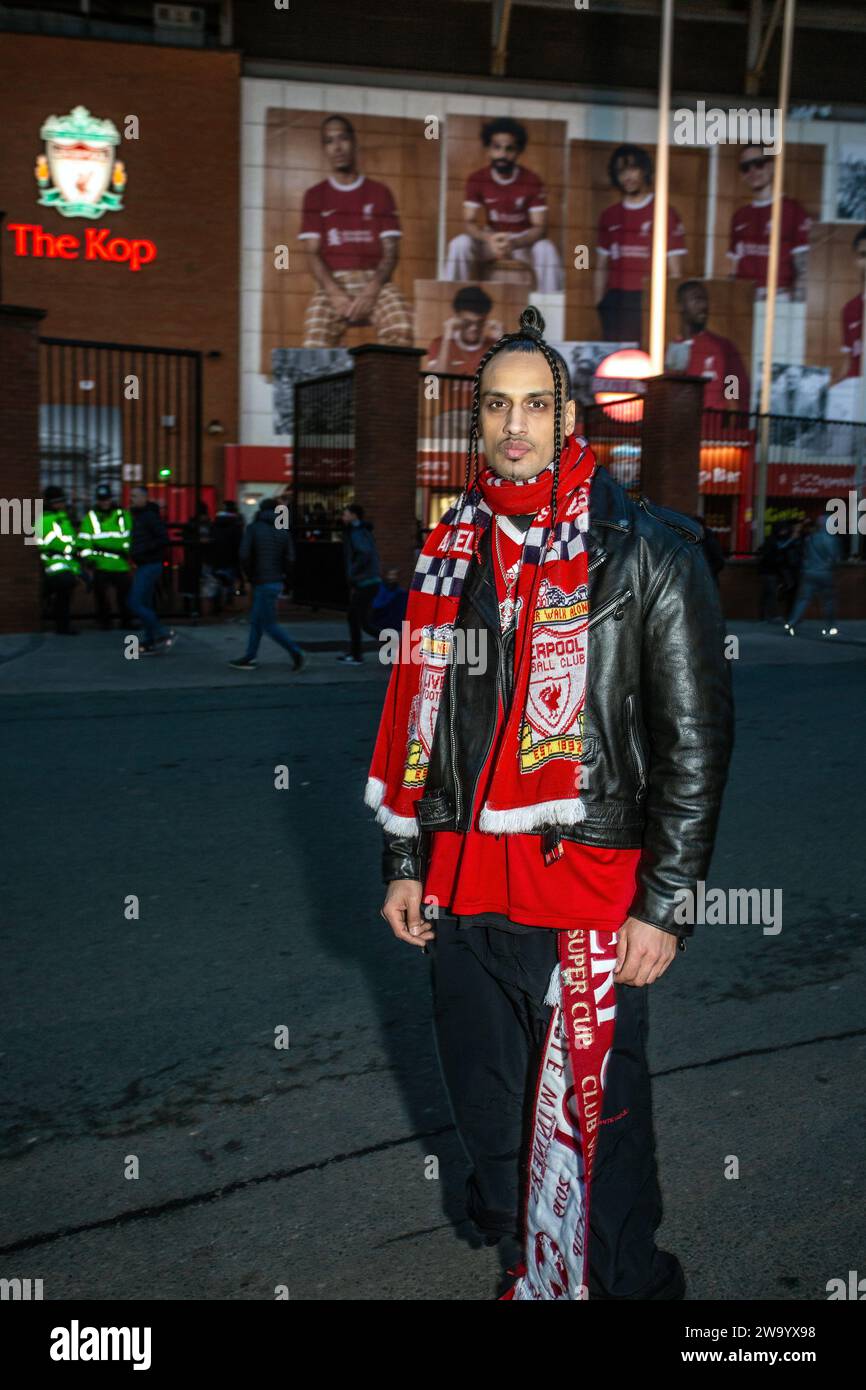 Young Liverpool FC supporter wearing Leatherjacket with Liverpool FC scarf in front of the Kop ,Football Stadium in Anfield, Liverpool , UK. Stock Photo