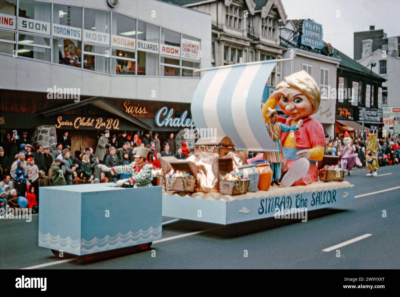 A parade float taking part in Eaton's Santa Claus Parade on Yonge Street, Toronto, Ontario, Canada, November 17, 1962. This float features the fictional character Sinbad the Sailor. There are treasure chests of jewels and a giant papier-mache figure of Sinbad wearing a gold turban. Attracting large crowds, the annual Toronto Santa Claus Parade (also known as The Original Santa Claus Parade) was first held in 1905 and is one of the largest in North America and the oldest Santa Claus parade in the world. It used to terminate at the downtown Eaton's store (later the Eaton Centre). Stock Photo