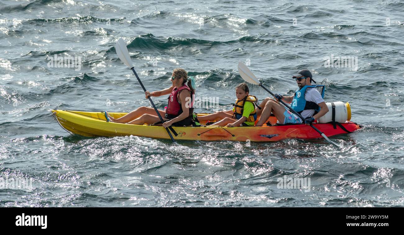 A family Kayaking at sea. Fornells Menorca Spain Stock Photo