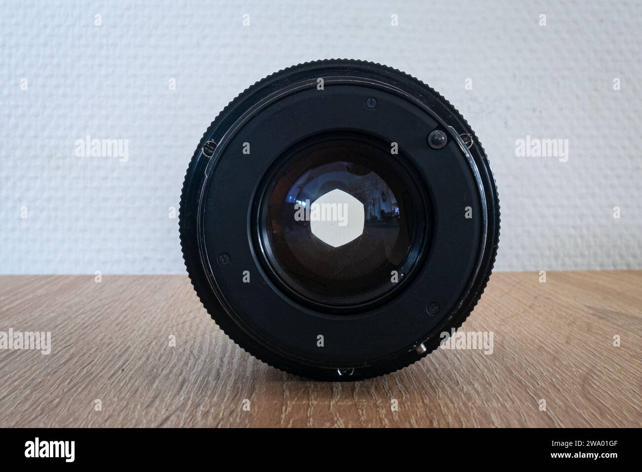 Aperture opening of a photographic lens on a table. Stock Photo