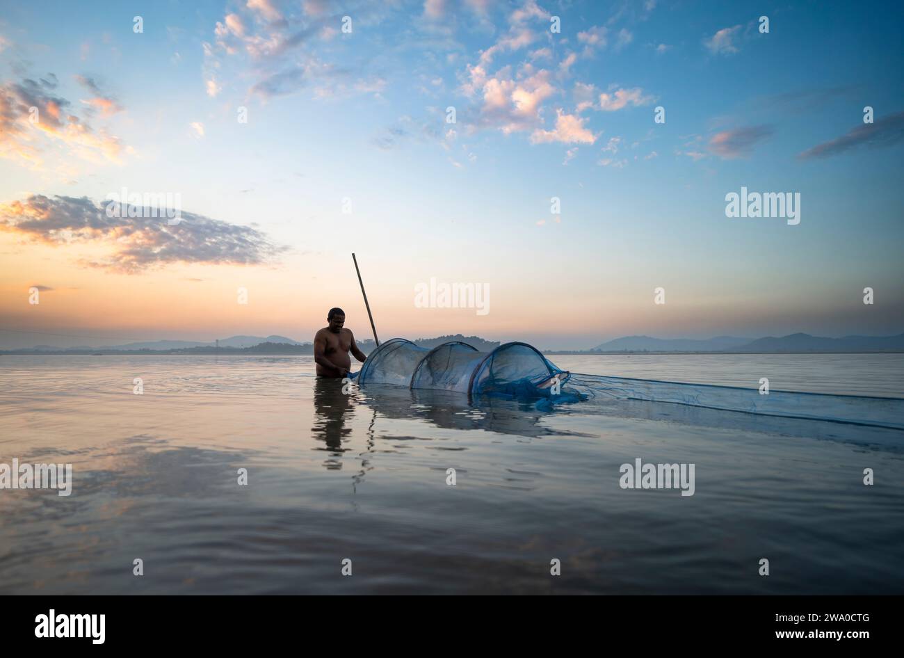 Guwahati, Assam, India. 31 December, 2023. A fisherman prepare to lay his fishing net in the