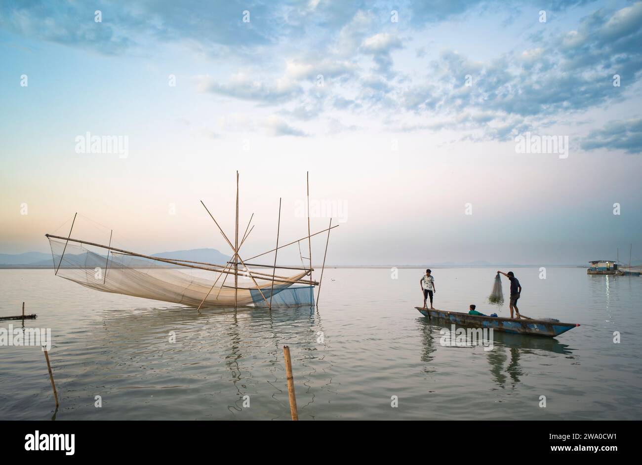 Guwahati, Assam, India. 31 December, 2023. Fishermen prepare their fishing net in the bank of