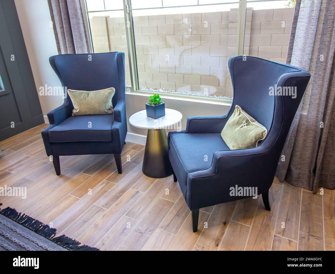 Two High Back Easy Chairs In Master Bedroom Stock Photo