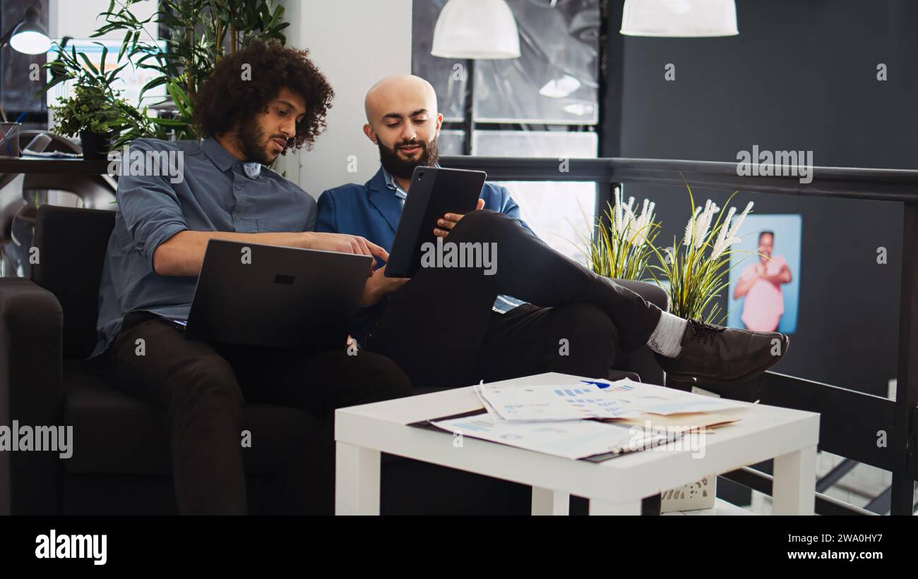 Two managers checking reports and official documents in coworking space ...