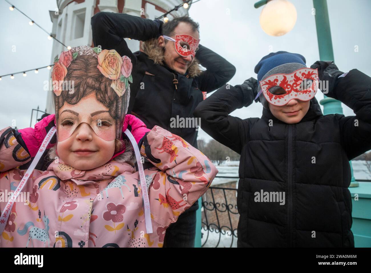 Moscow, Russia. 31st of December, 2023. People wearing carnival masks attend the New Year and Christmas festival 'Moscow Estates. Winter' in Moscow, Russia. The festival will run from 22 December to 08 January 2024 at 15 venues in Moscow. It includes more than 400 events, New Year and Christmas balls, children's performances, lectures, folklore festivities, quests, and tea parties. Russians are preparing to celebrate New Year's Eve on 31 December and Christmas, observed on 07 January, according to the Russian Orthodox Julian calendar Stock Photo