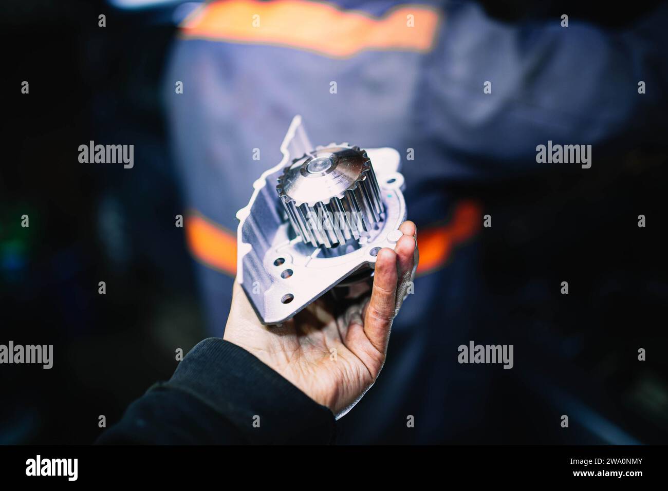 Automotive water pump of the engine cooling system in the hands of an