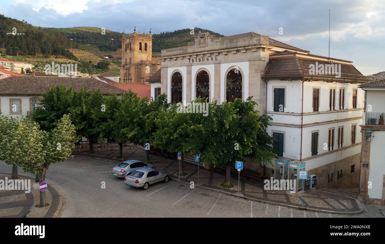 District Court building in the main town square, bell tower of the Gothic Cathedral in background, view in sunset light, Torre de Moncorvo, Portugal Stock Photo