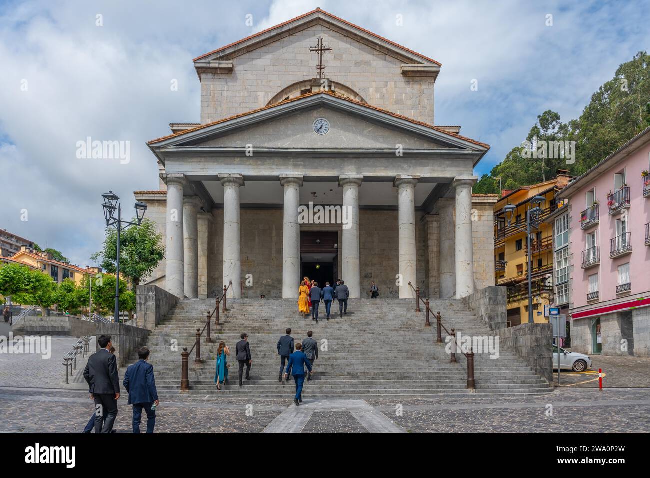 People entering the church of Our Lady of the Assumption in the coastal town of Mutriku, Basque Country Stock Photo