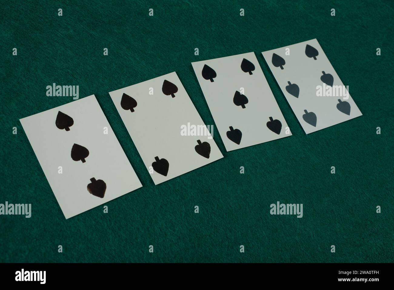 Old west era playing card on green gambling table. 3,4,5,6 of spades. Stock Photo