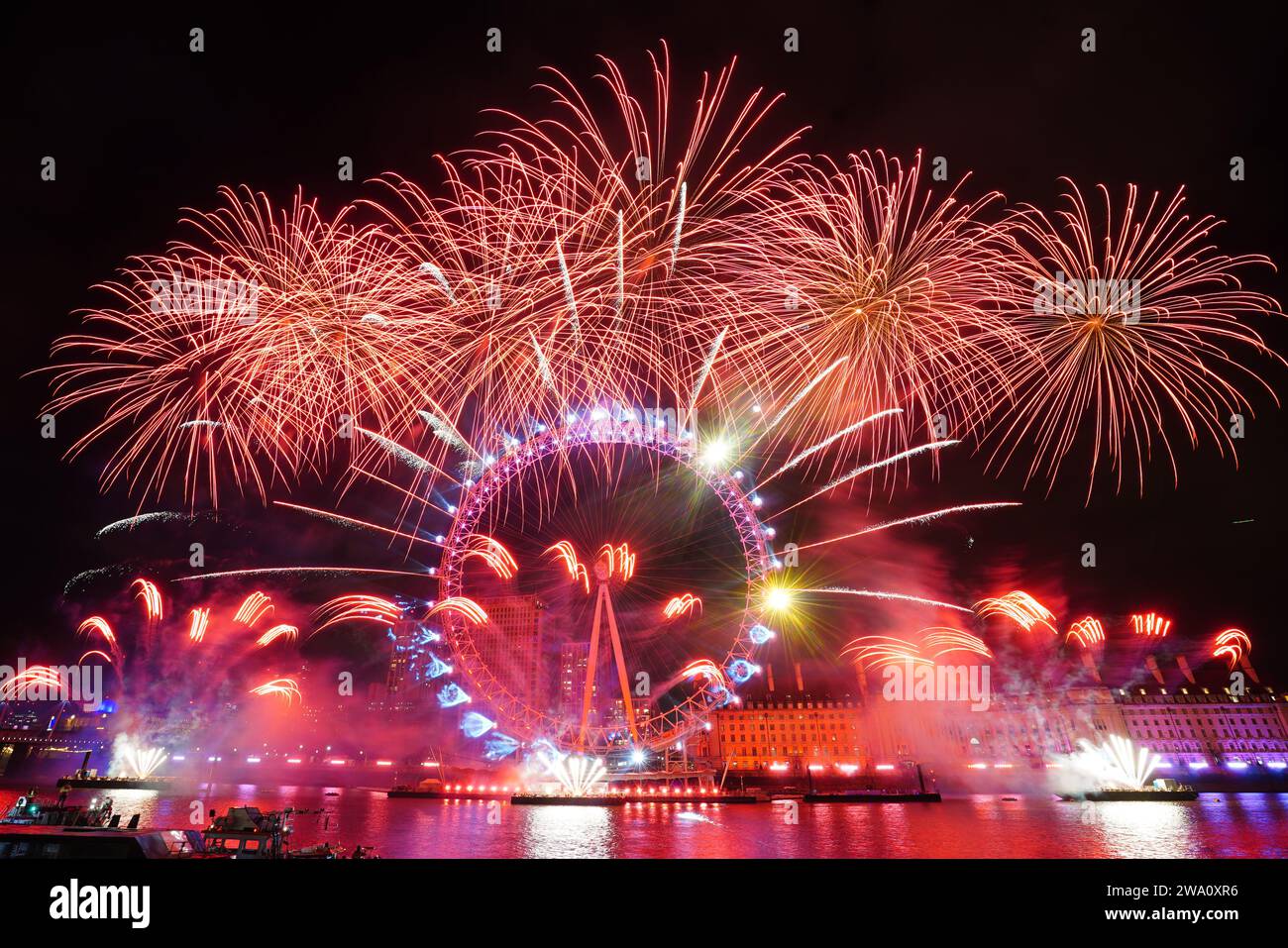 Fireworks light up the sky over the London Eye in central London during